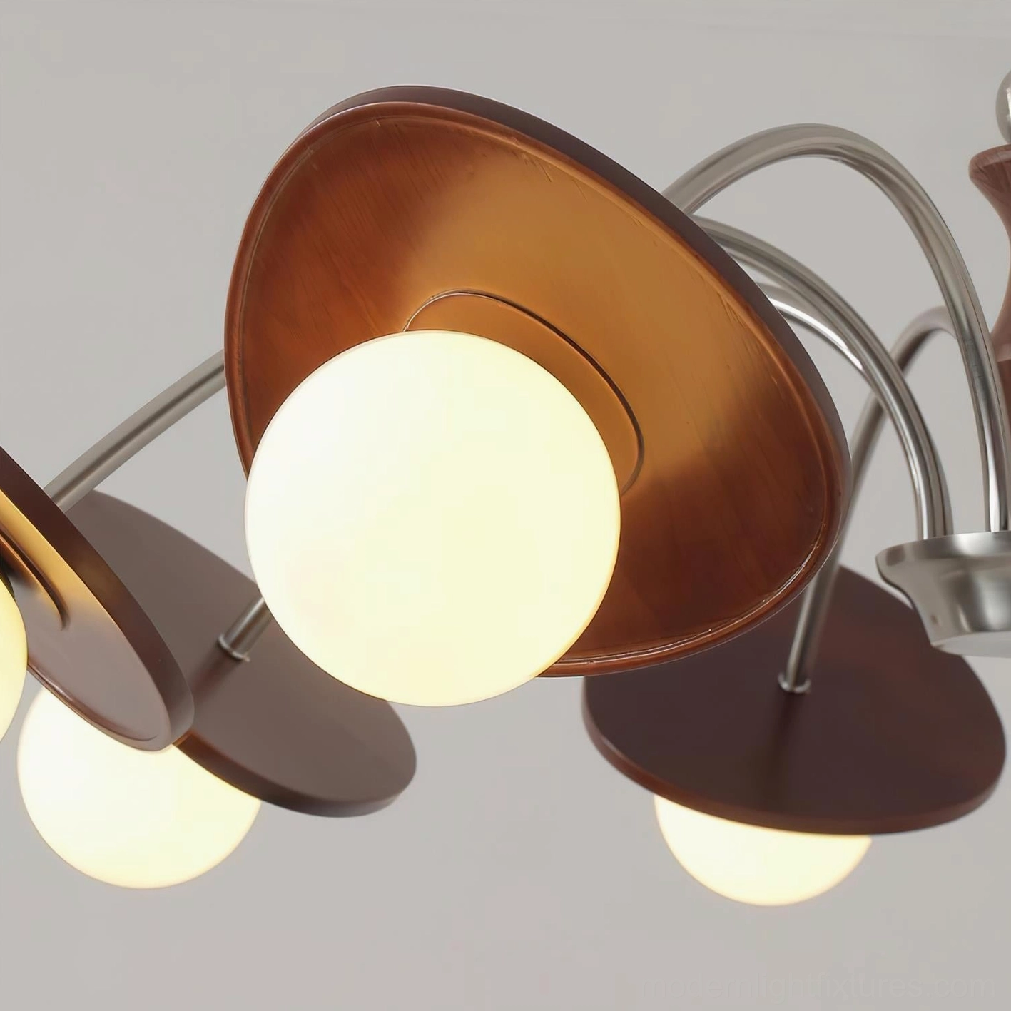Mid-century modern orbital chandelier showcasing sculptural design with multiple frosted glass globe shades and arched arms