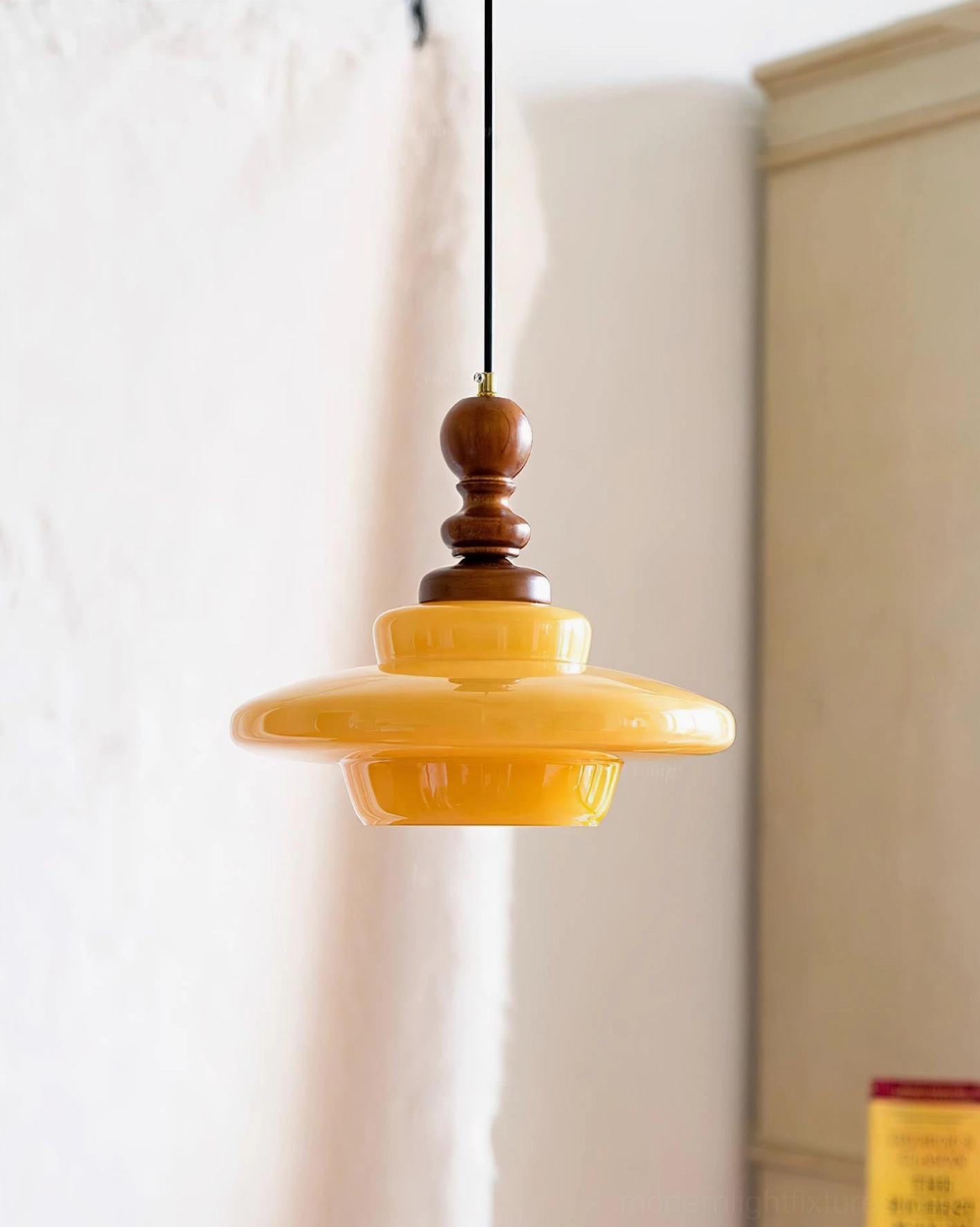 Retro mid-century pendant lamp with golden amber glass shade and wooden top hardware, product photography