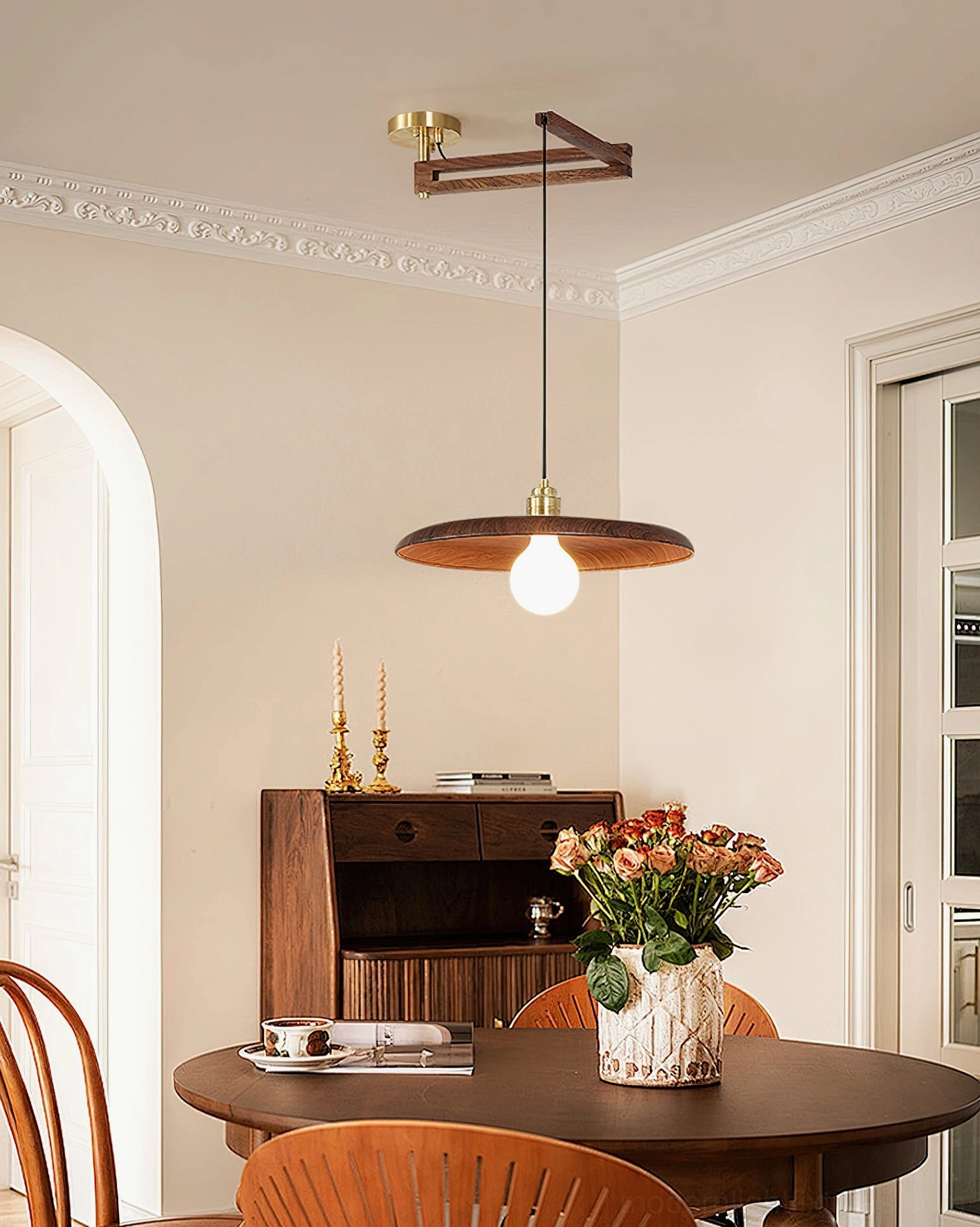 Mid-century modern pendant light fixture above formal dining room wooden table
