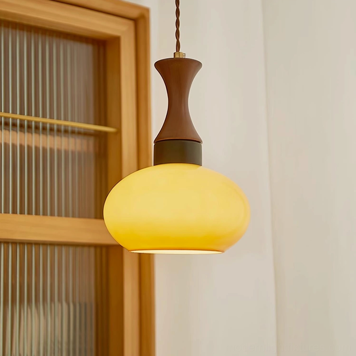 Mid-century hanging pendant light with wood fixture cap and golden glass shade