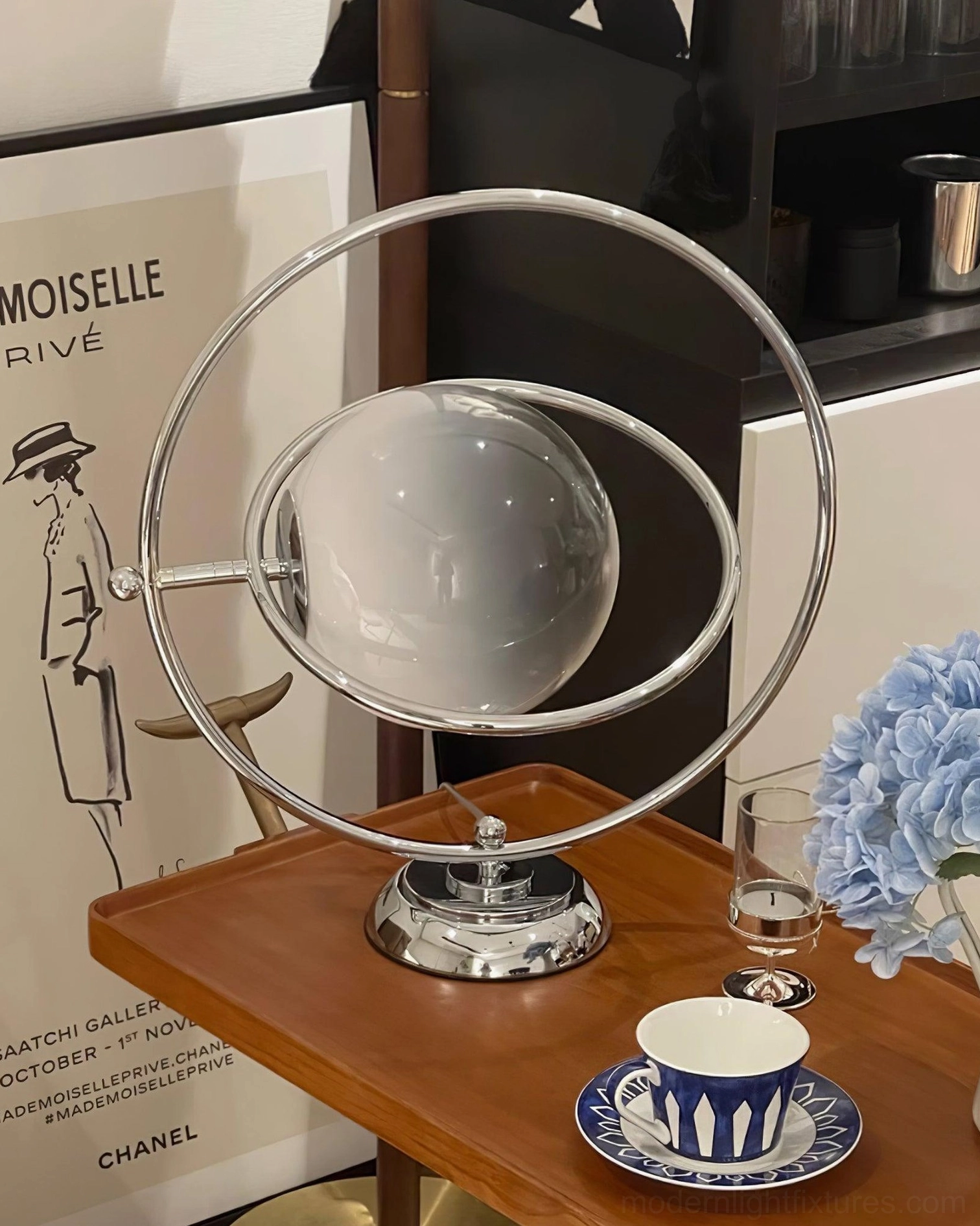 Modern sphere table lamp with frosted glass shade in retro home décor scene with flowers and art