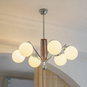 Mid-century sputnik chandelier illuminated in residential entryway, warm ambient lighting, architectural design photography