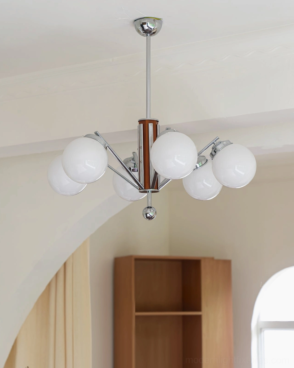 Mid-century sputnik chandelier side view in residential interior, chrome and walnut wood details, frosted glass shades