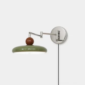 Modern olive green plug-in swing arm wall sconce with polished chrome hardware and wooden accent detail, front view on white studio background
