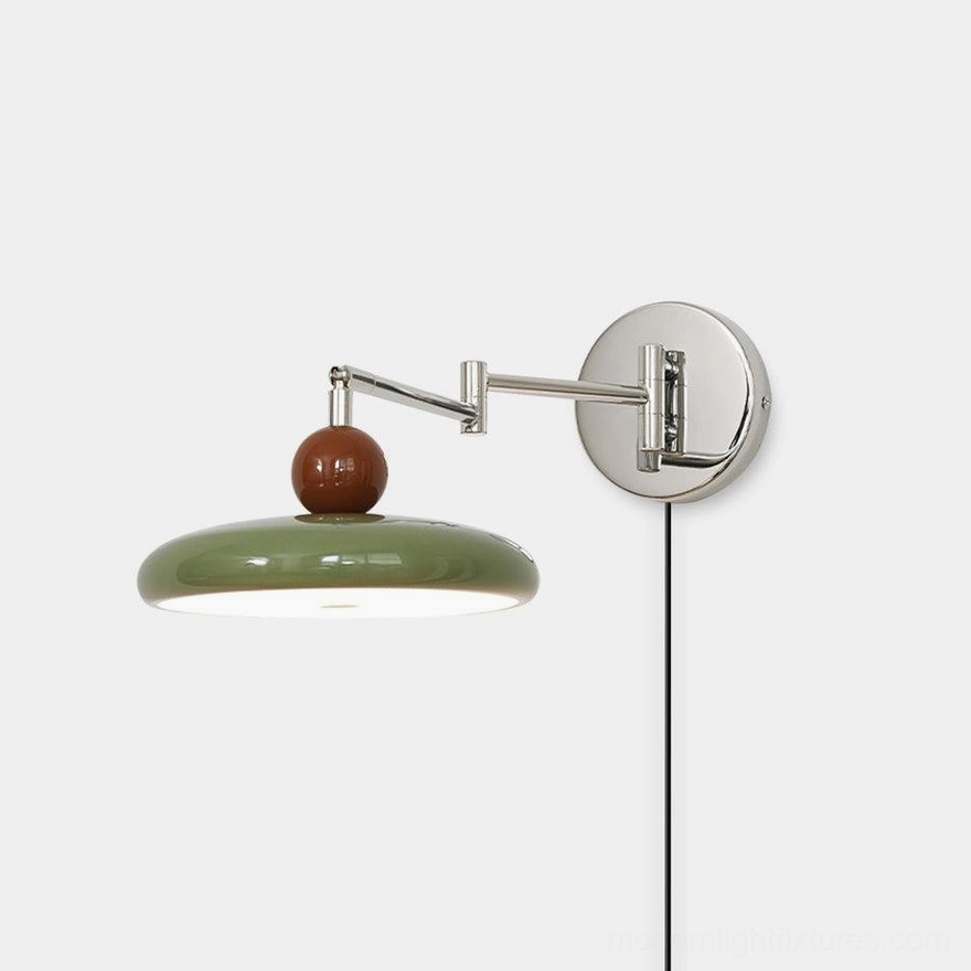 Modern olive green plug-in swing arm wall sconce with polished chrome hardware and wooden accent detail, front view on white studio background