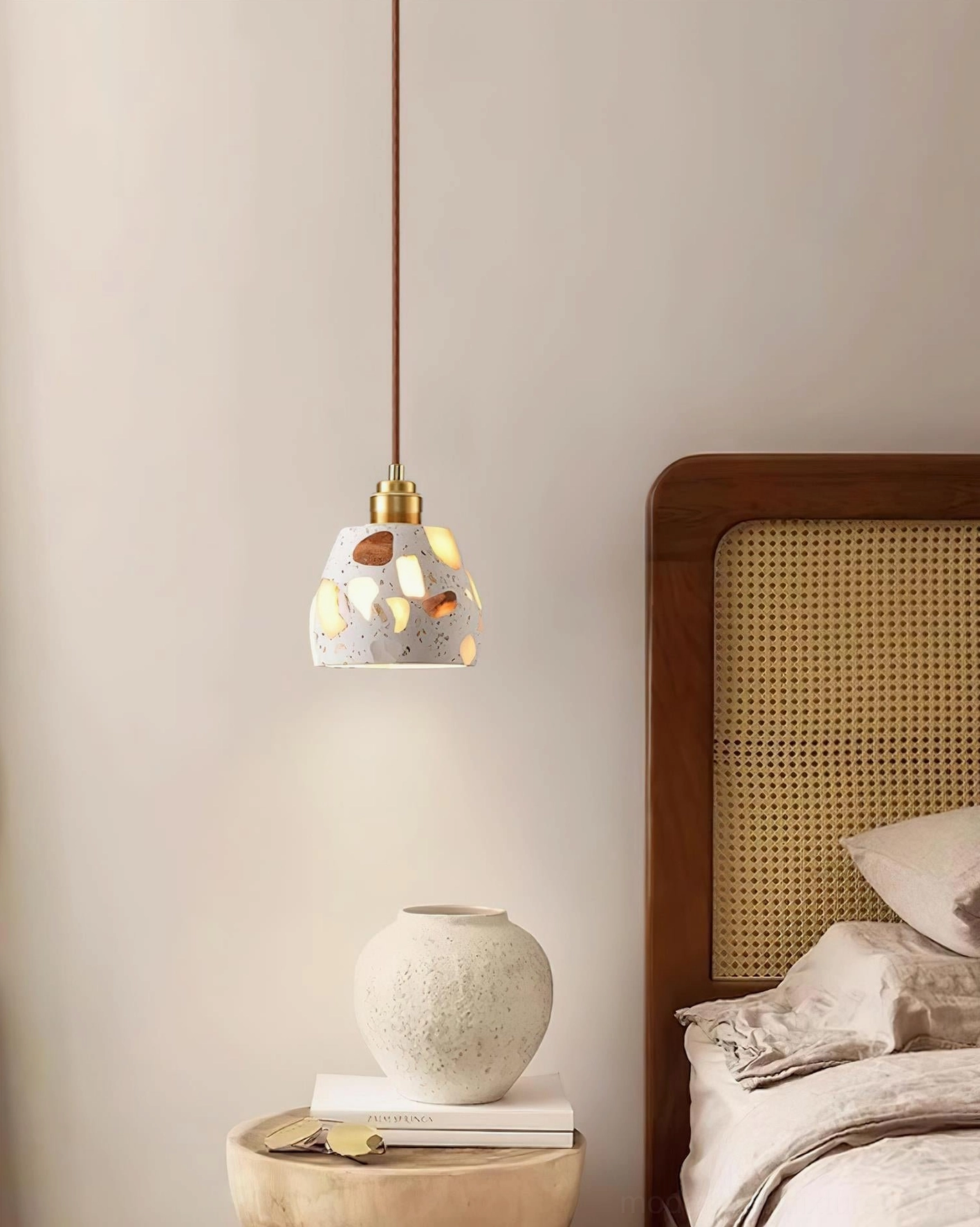 Mid-century style terrazzo pendant light with natural light diffusion through stone shade