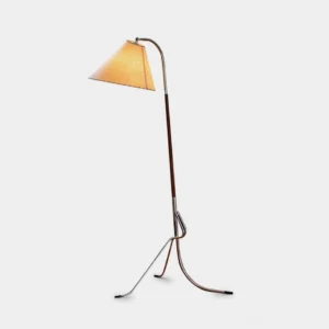 Mid-century tripod floor lamp front three-quarter view on white studio background, showing chrome metal stand and walnut wood pole with adjustable arm