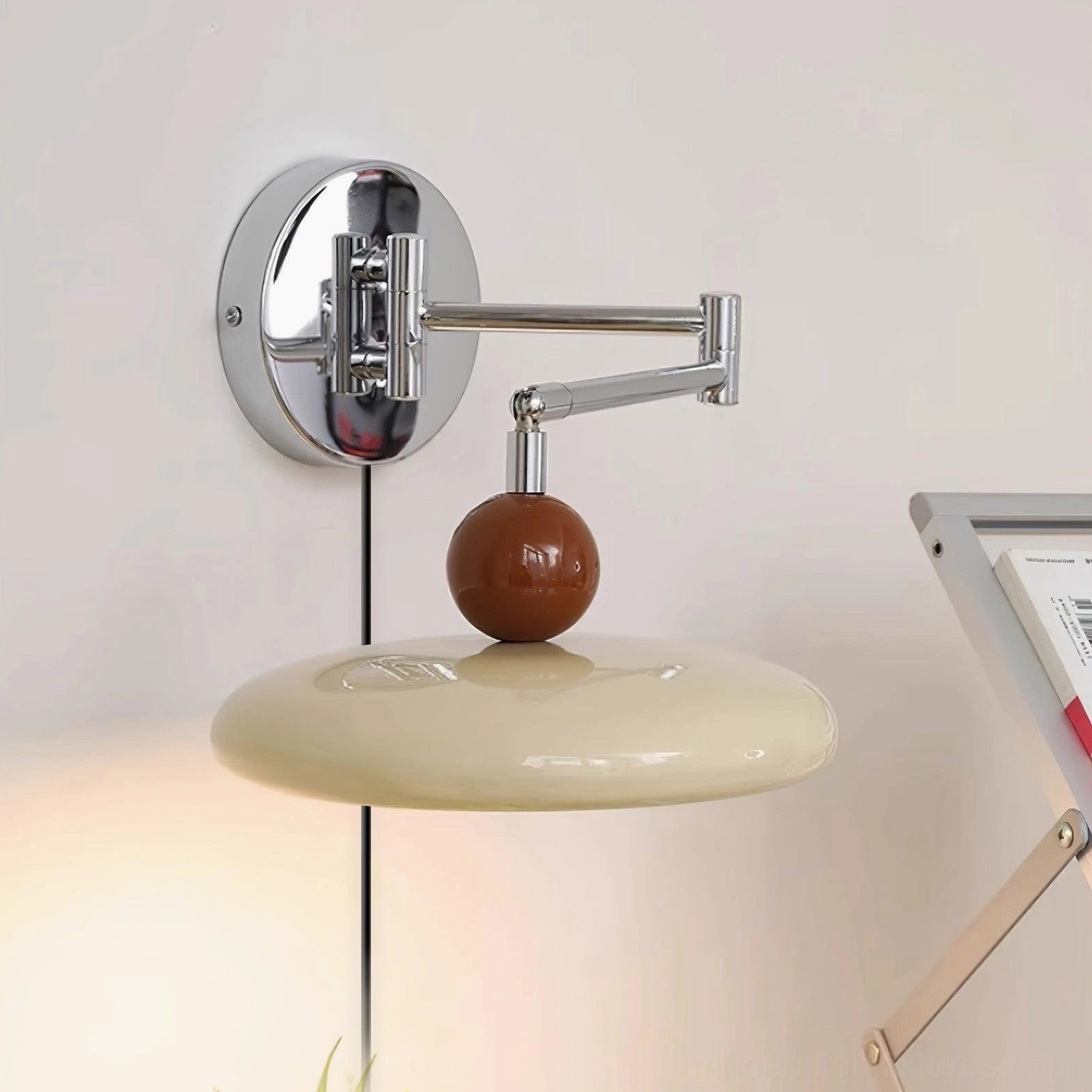 Mid-century modern plug-in wall sconce with white shade and extended swing arm for flexible task lighting