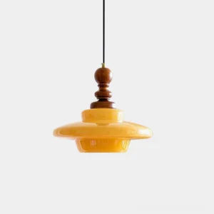 Mustard yellow glass pendant light with walnut wood fixture, studio view showing warm amber shade and wooden top component