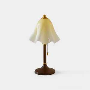 Mido draped glass table lamp with walnut wood base and brass accents, front studio view