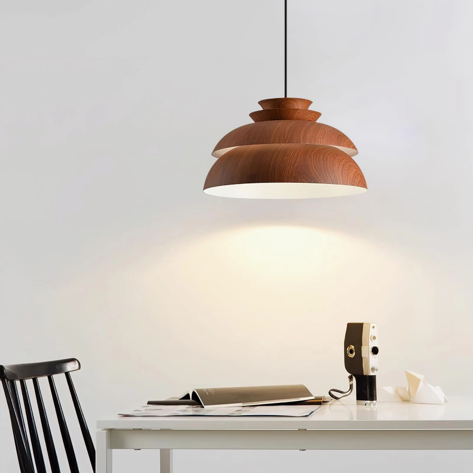 Midori tiered wood pendant light above desk with warm downlighting and brown shade in study