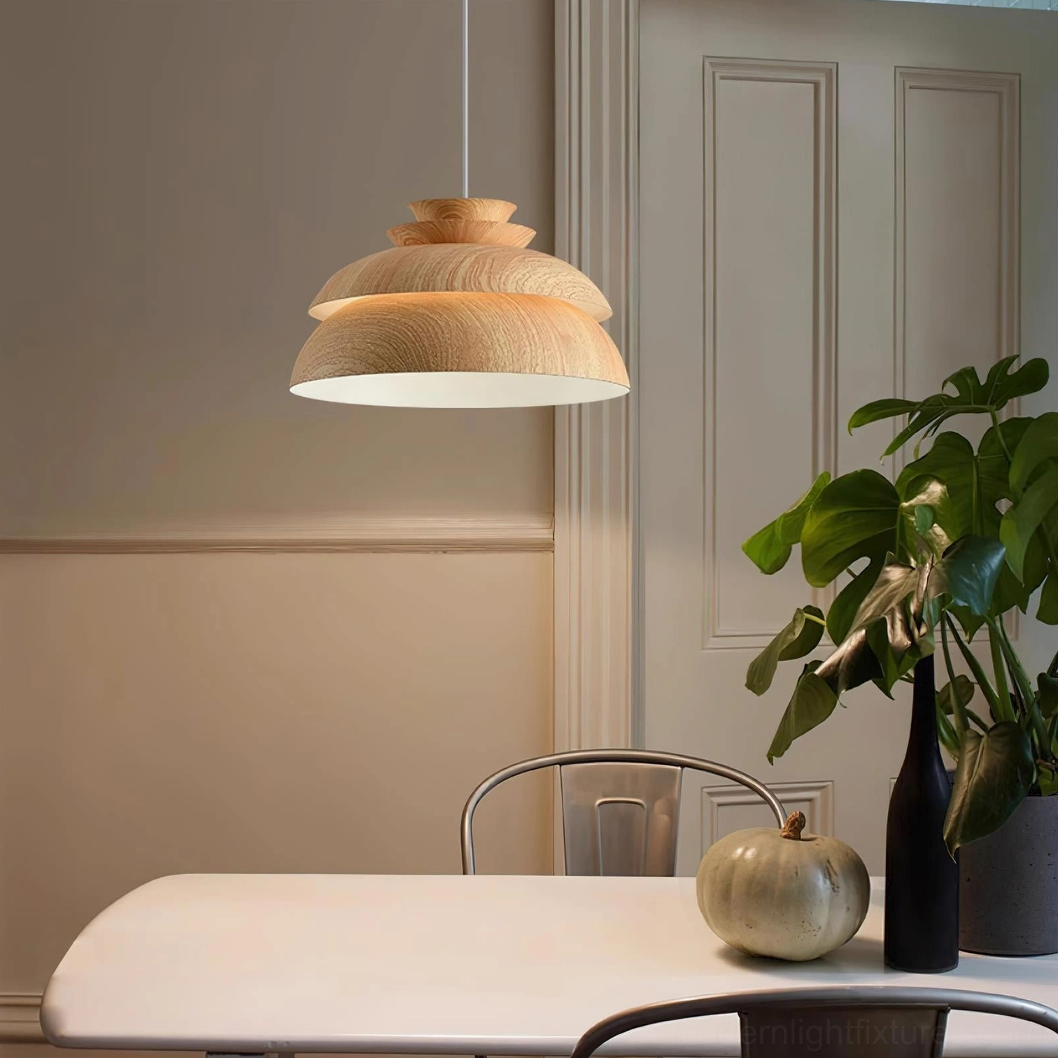Midori tiered pendant light with light wood texture above casual dining area with decorative plant