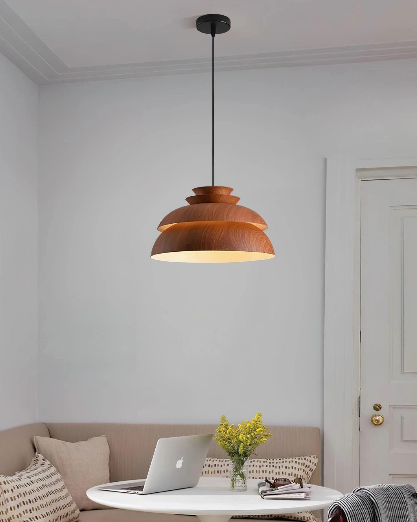 Single Midori modern pendant light with brown wood finish and black cord in lounge living room