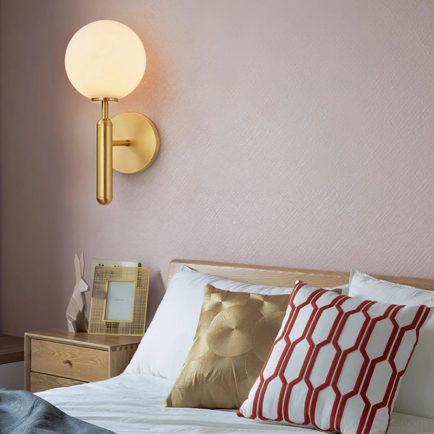 Miira bedside wall sconce creating ambient bedroom lighting, master bedroom installation with patterned pillows