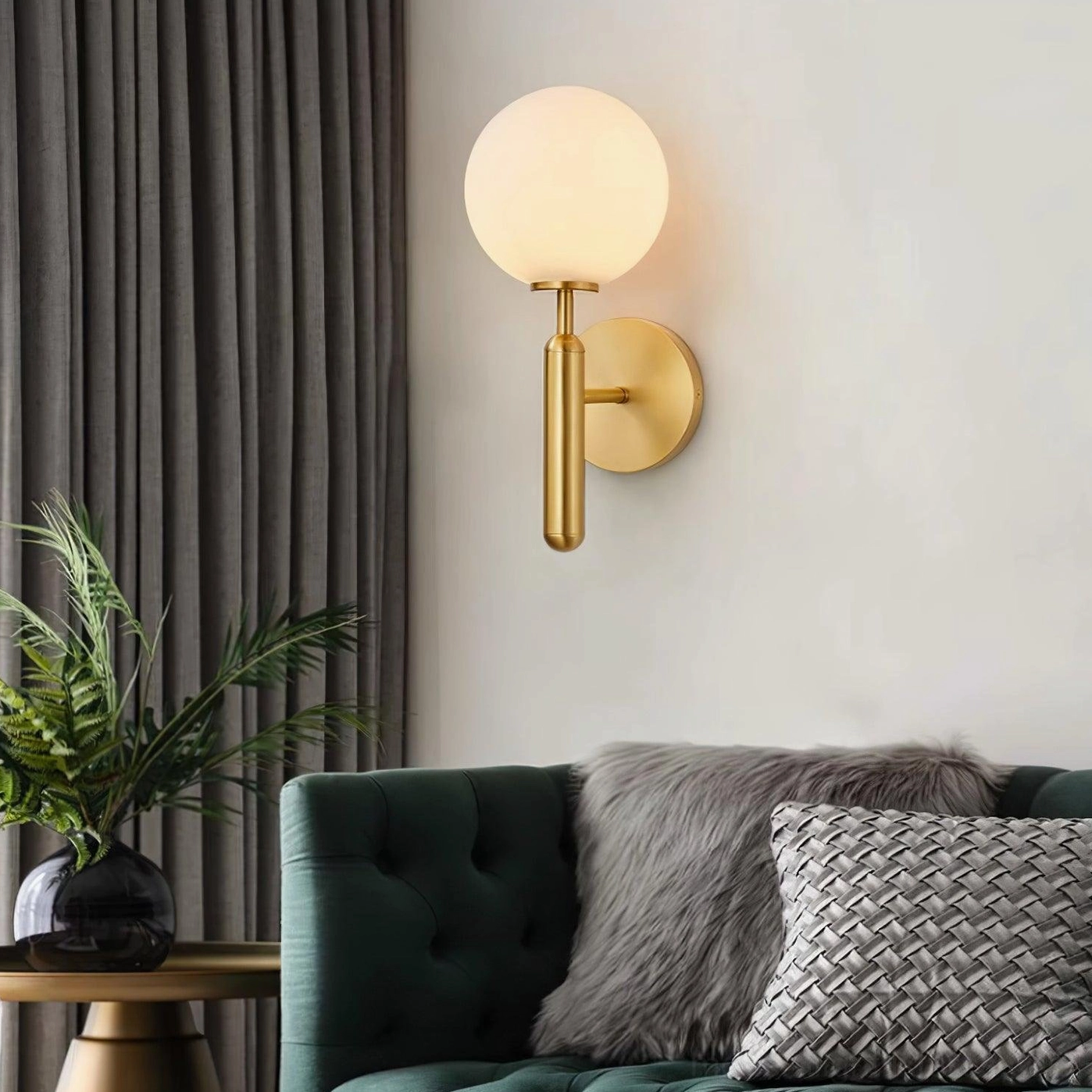 Nordic wall sconce Miira in contemporary living room setting, three-quarter view with green sofa and plant