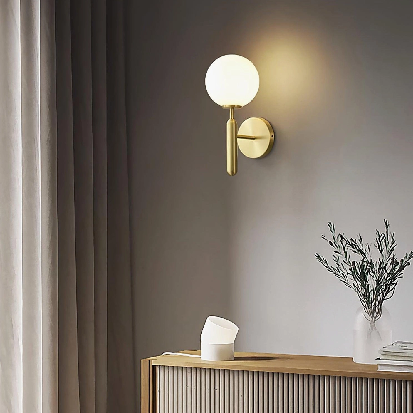 Miira wall sconce showing dimmer-compatible warm ambient lighting in residential space