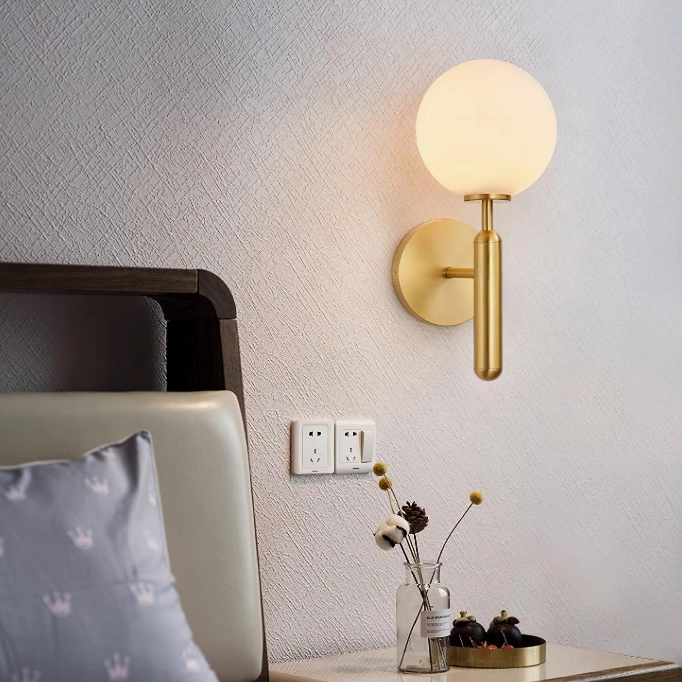 Elegant Miira brass globe sconce in home setting, versatile modern lighting for multiple rooms