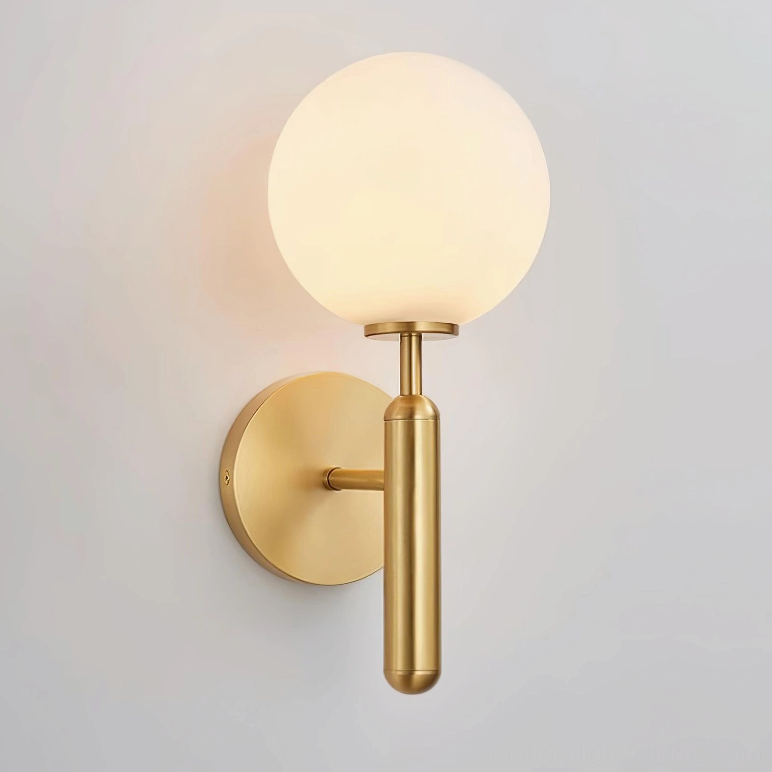 Miira globe wall sconce in gold brass finish, modern Nordic design fixture for residential interiors