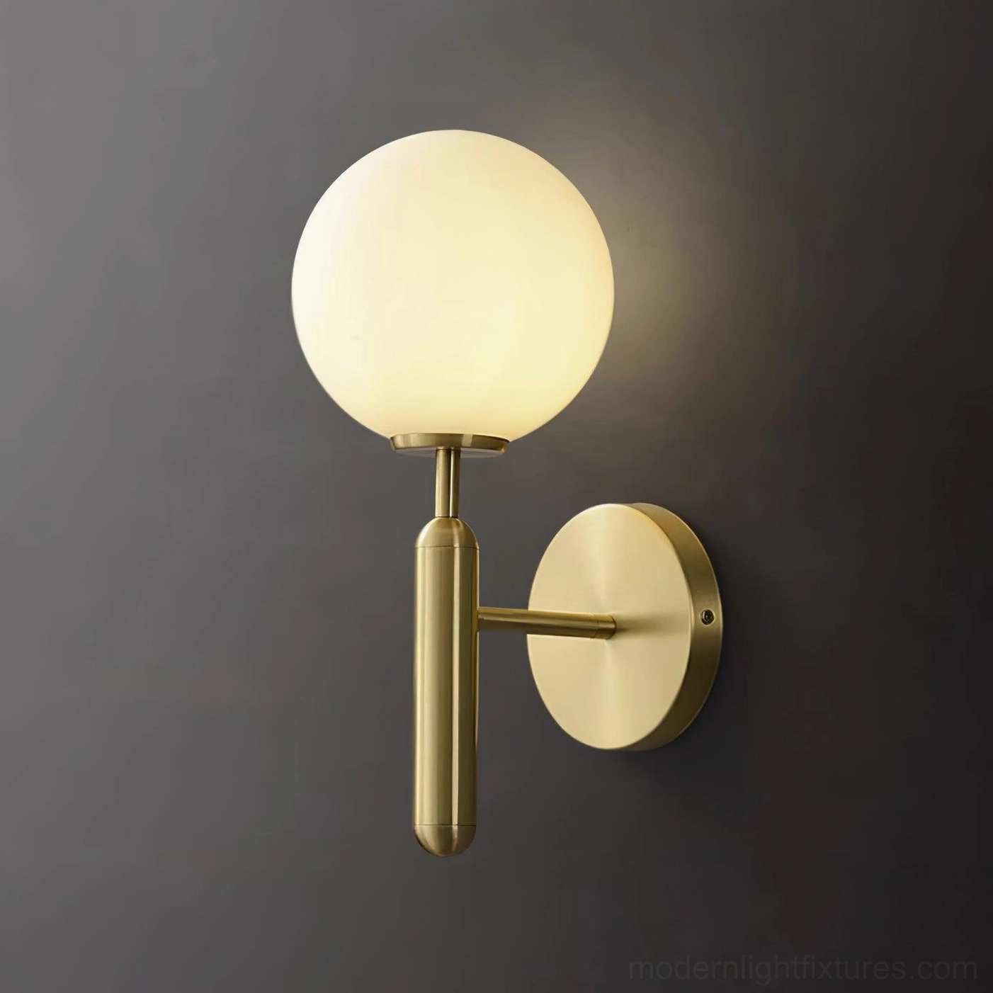 Miira brass wall sconce paired with contemporary home furnishings, modern interior design application