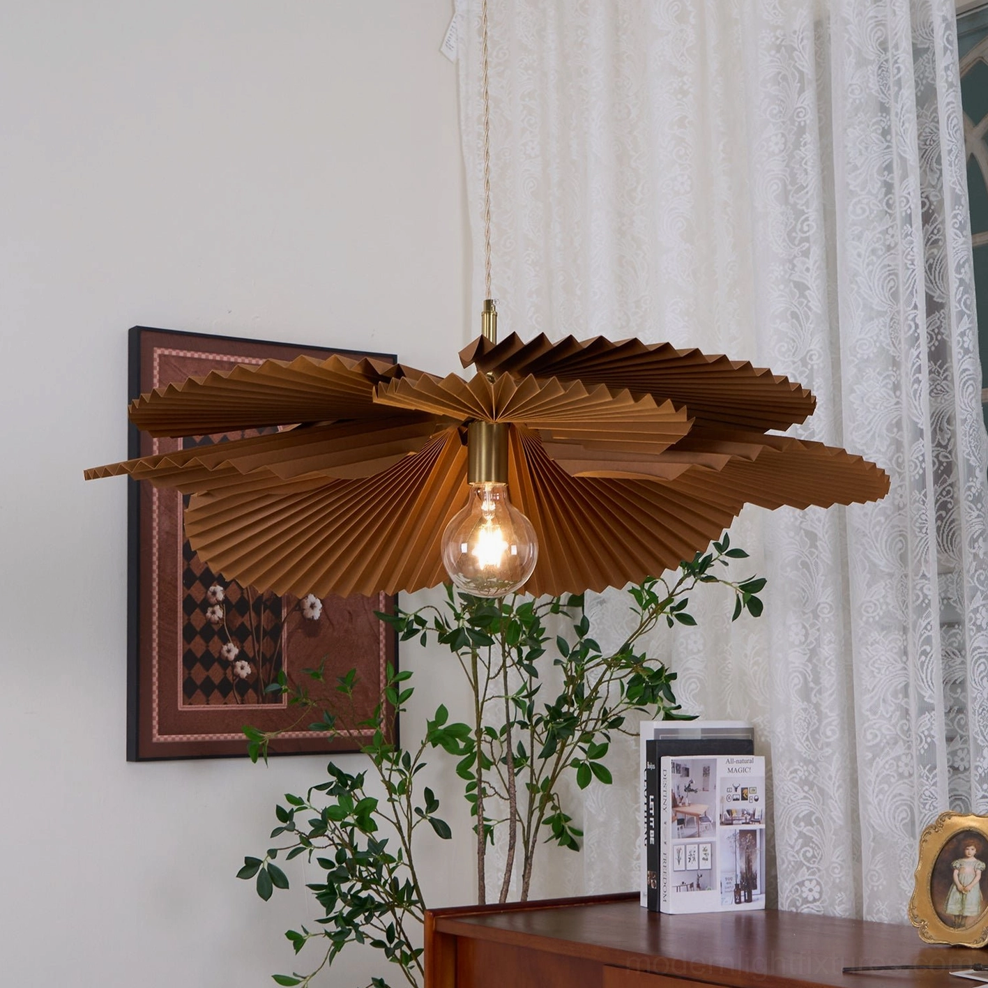 Mikado sculptural pendant lamp hung in vintage home office with desk, green plant, and wall art showing warm bohemian aesthetic