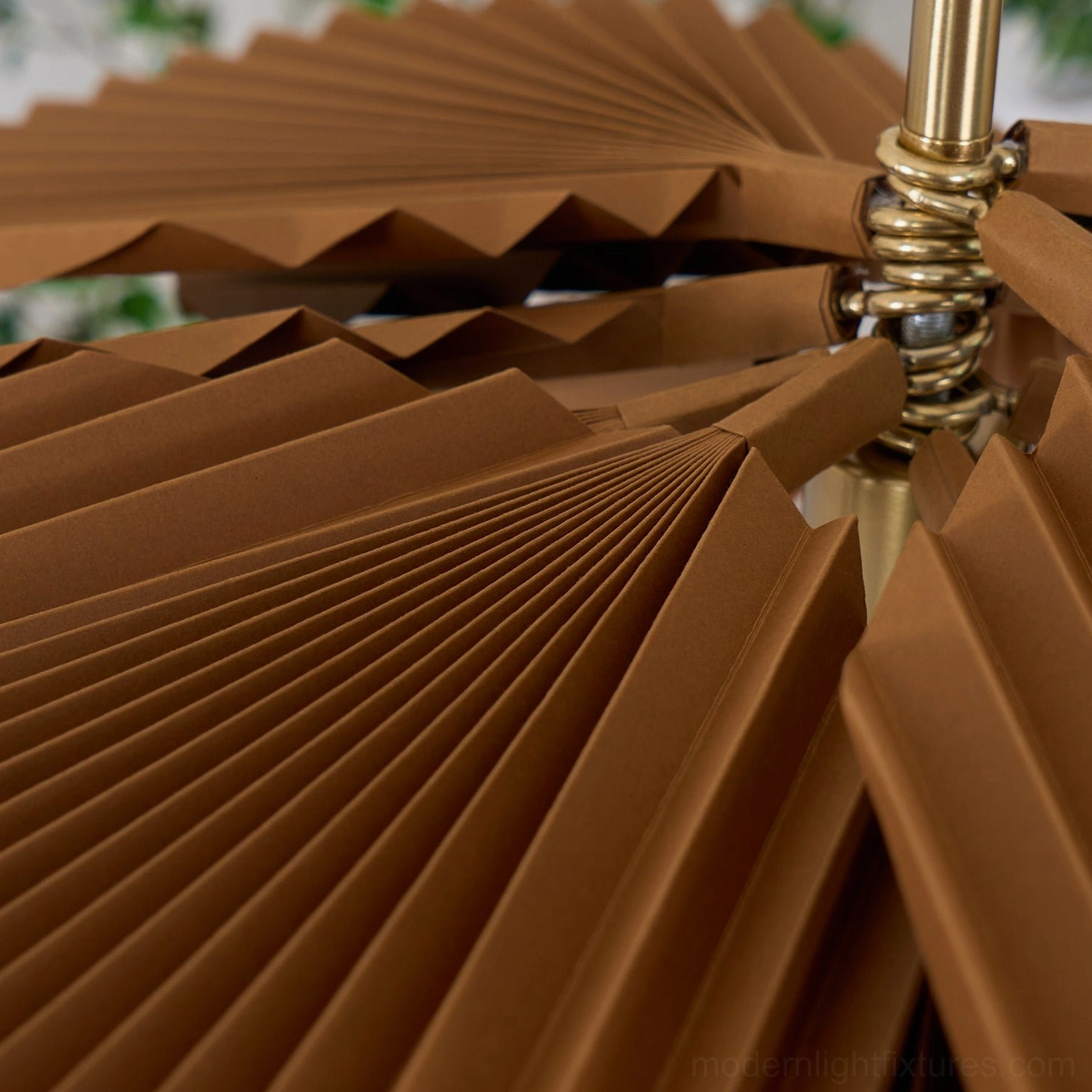 Macro detail shot of Mikado pendant light showing brown kraft paper pleats and brass metal connection hardware