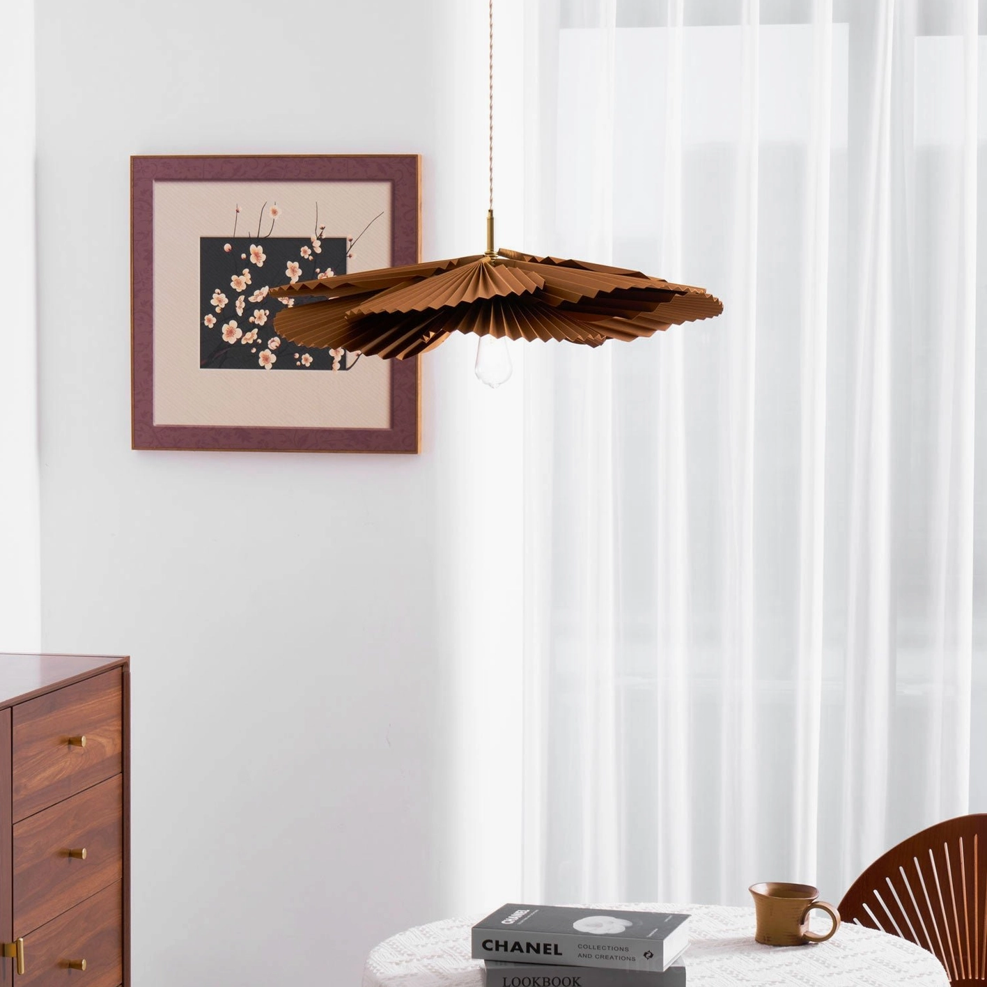 Mikado sculptural pendant fixture in Scandinavian interior with layered textiles and natural wood elements