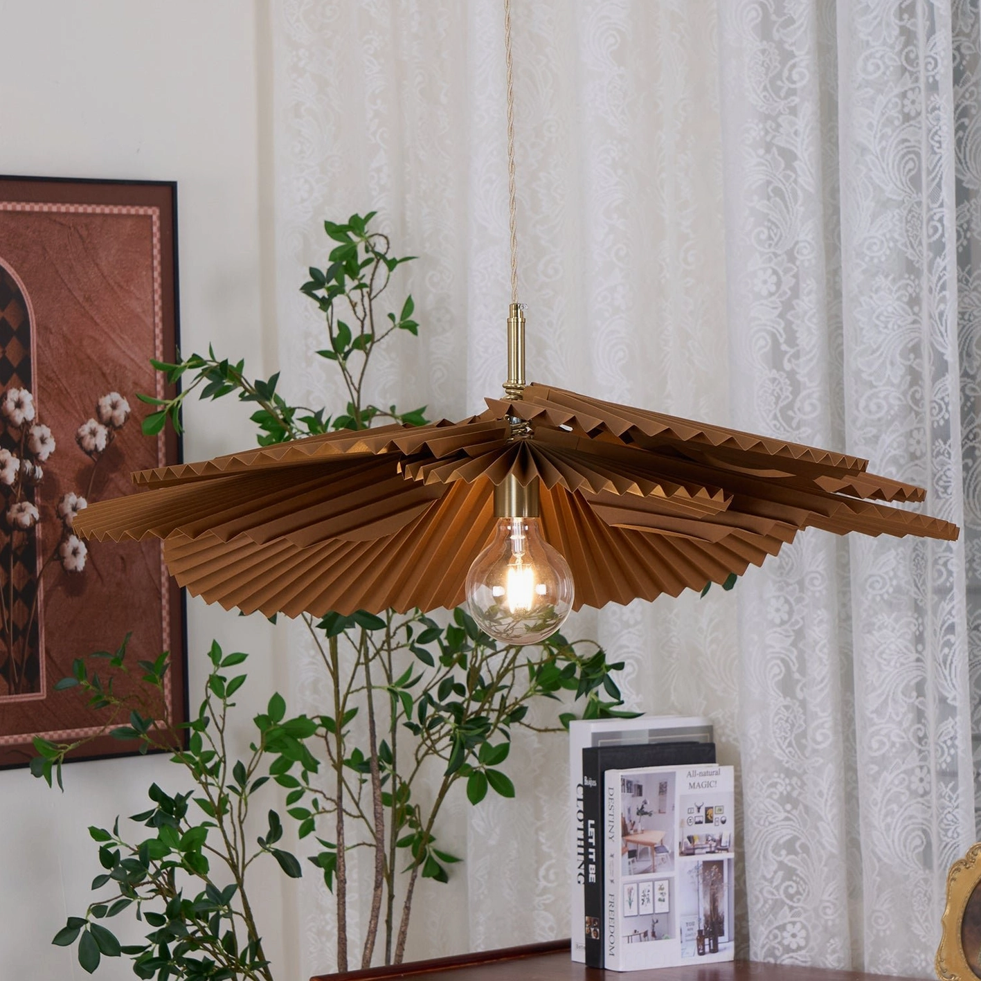 Mikado sculptural pendant light from three-quarter view in vintage home setting with wall art and lace window treatments
