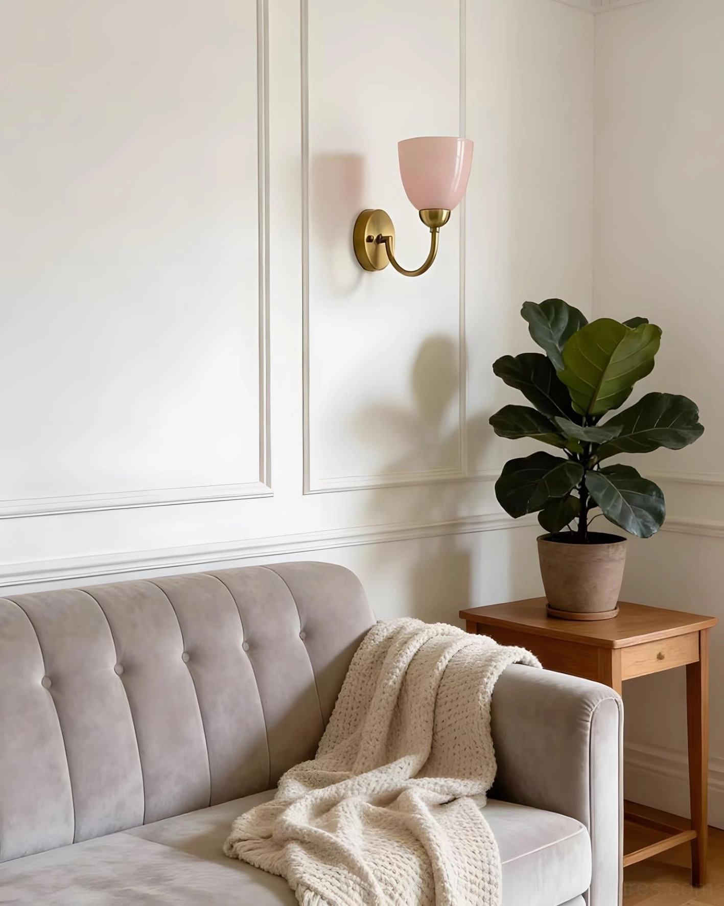 Mild Velin pink wall sconce in formal living room with grey tufted sofa and fiddle leaf fig plant