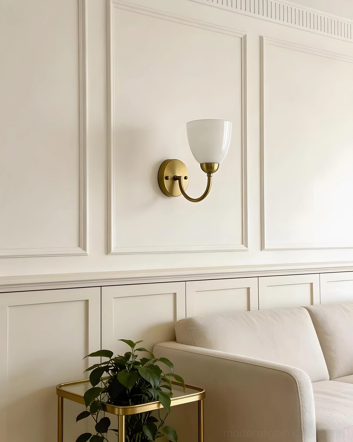 White frosted glass Mild Velin wall sconce on minimalist wainscot with beige sofa and plant