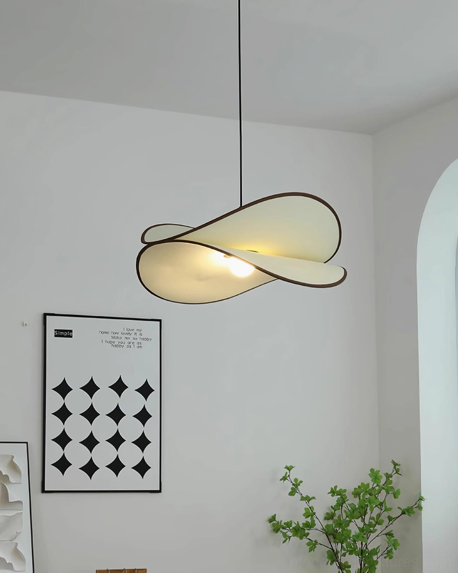 Miley curved petal pendant light front low-angle view in minimalist living room, glowing warm ambient light emanating from white fabric shade, nordic minimalist design