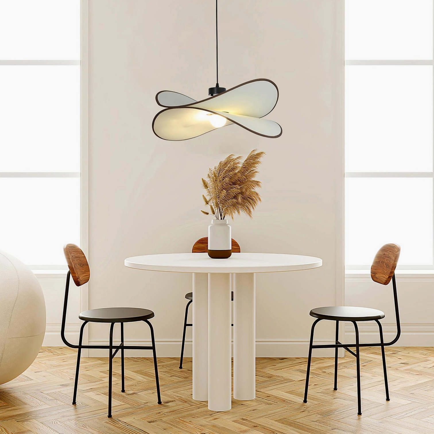 Miley twisted petal fabric pendant lamp three-quarter angle in modern dining room above round white table with leather chairs, warm minimalist aesthetic
