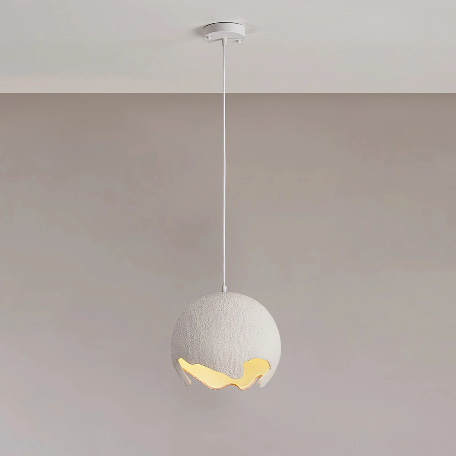 Milk coffee moon crater pendant ceiling fixture with medium matte textured shade, warm ambient light through bottom aperture