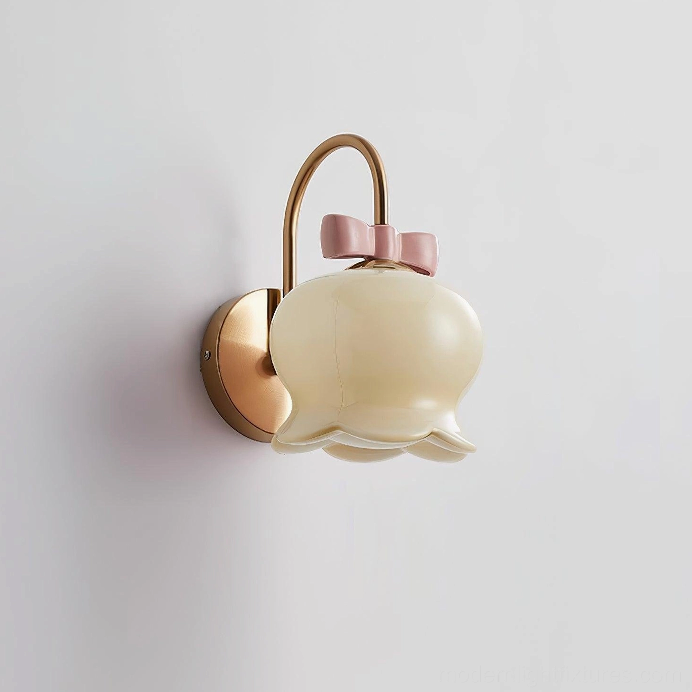 Millie Bells wall sconce featuring ceramic bell shade with metal mounting bracket and bow detail, modern lighting fixture design