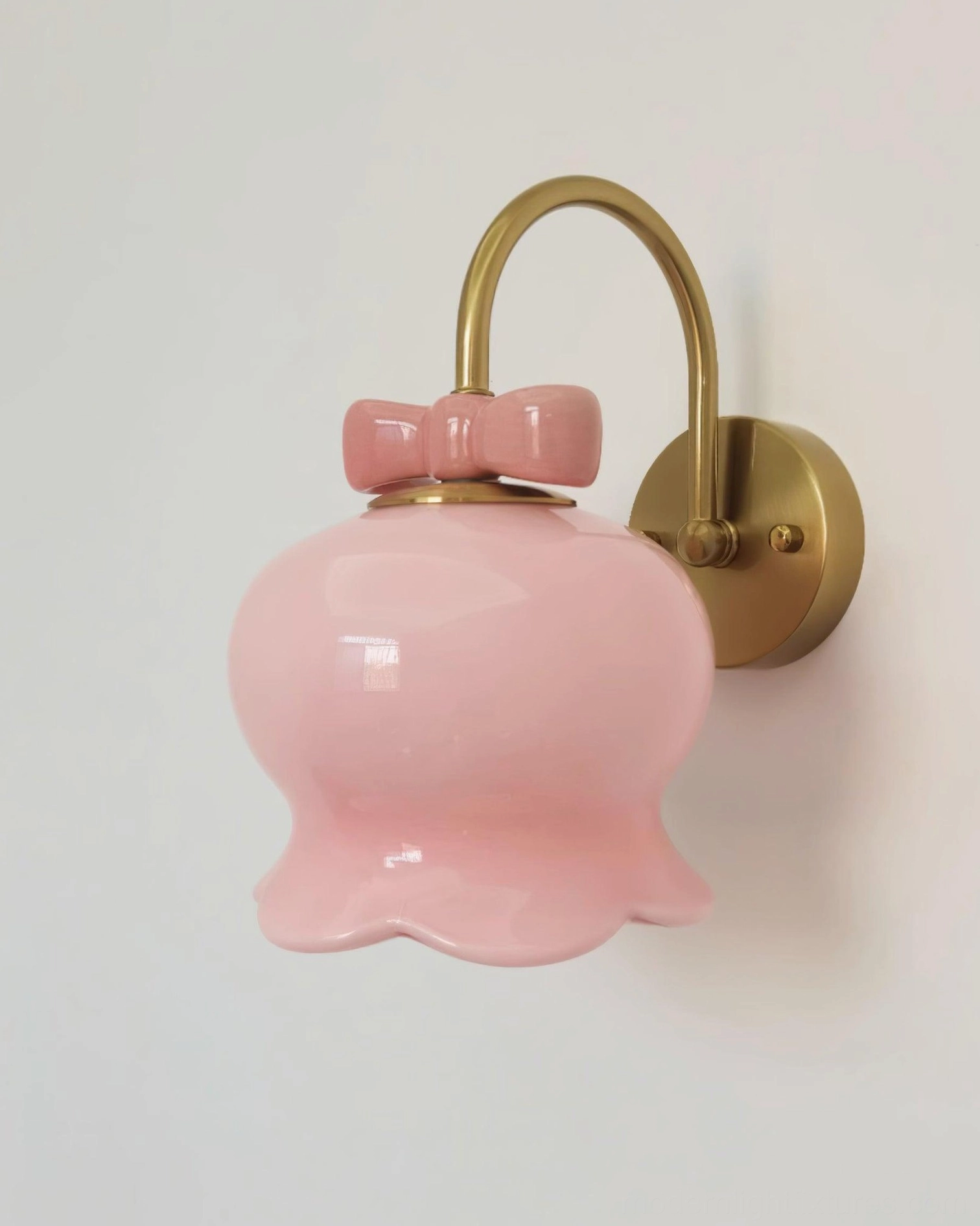 Millie Bells ceramic wall sconce with refined bell silhouette and bow detail, available in gold and chrome metal finishes