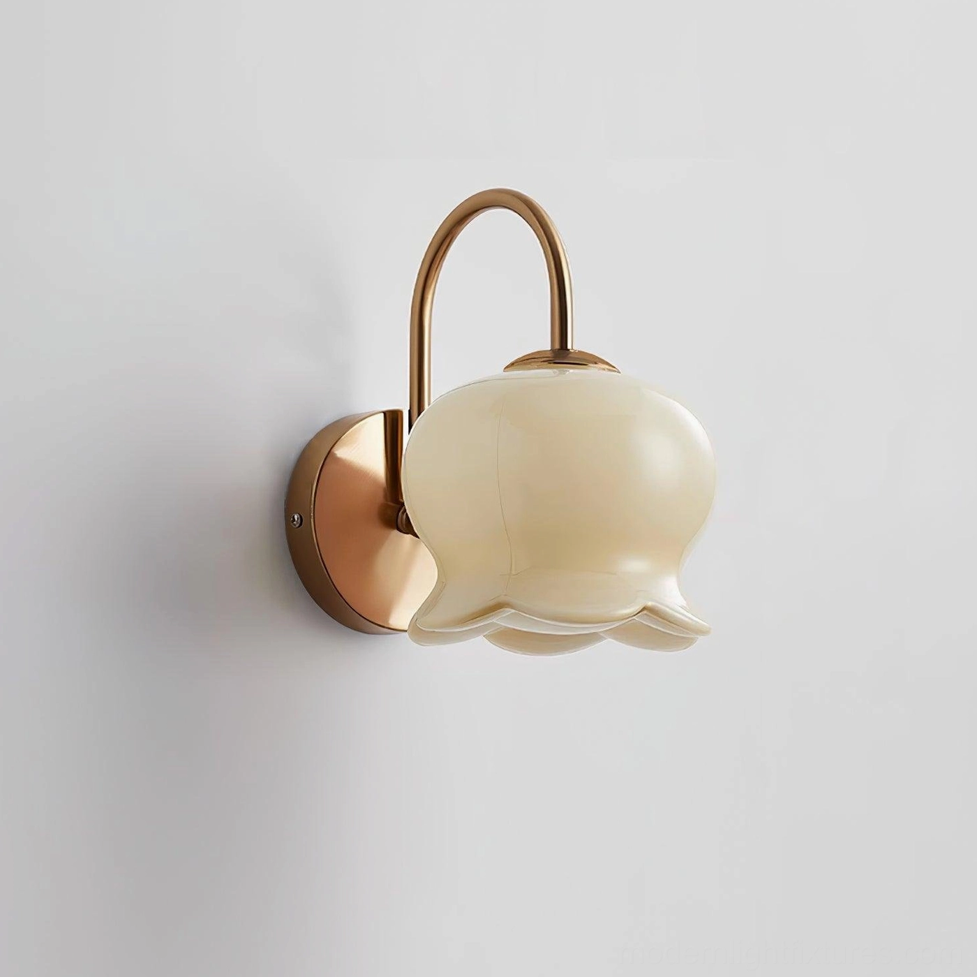 Whimsical Millie Bells wall sconce featuring lily-of-the-valley inspired ceramic bell shade with elegant bow and metal hardware