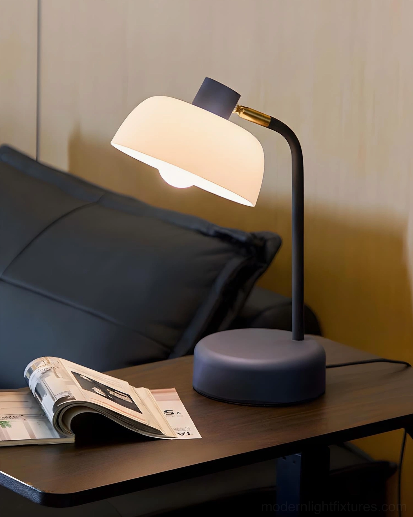 Color-block arc table lamp with navy blue base and gold accents on bedroom nightstand scene