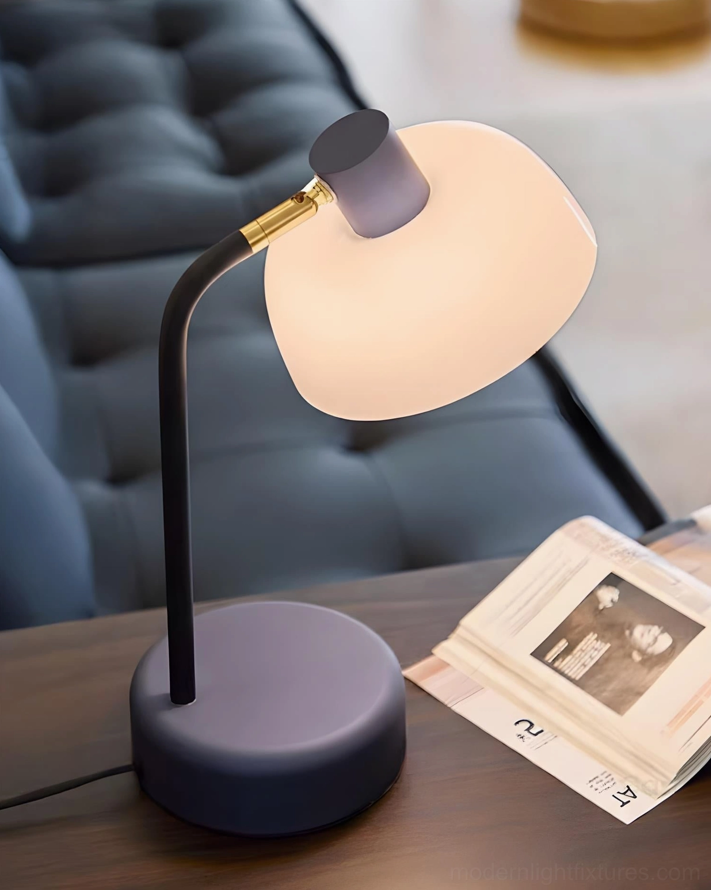 Modern minimalist arc lamp with gray matte base on living room coffee table with contemporary styling
