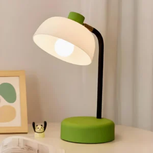 Modern arc table lamp with green base displayed on bedroom nightstand with Scandinavian interior styling