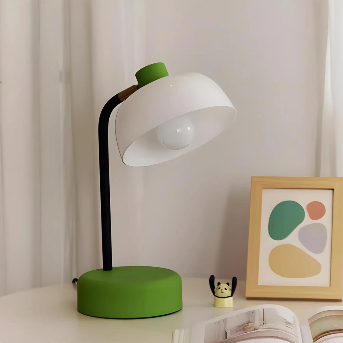 Green base arc table lamp displayed on bedroom side table with wall art and modern bedroom decor