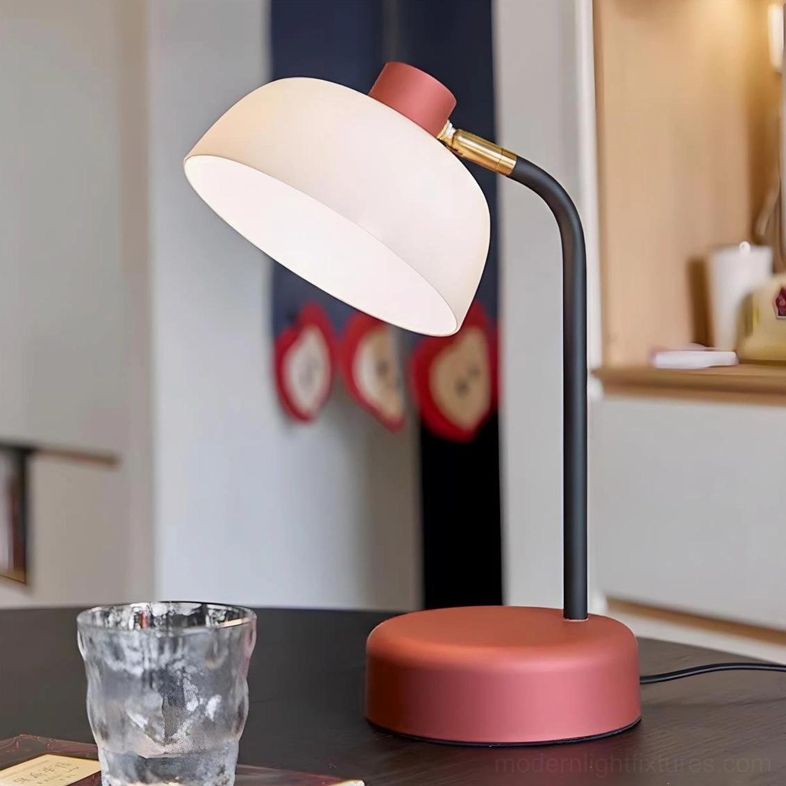 Nordic arc desk lamp with dusty rose base on interior side table scene with warm lighting