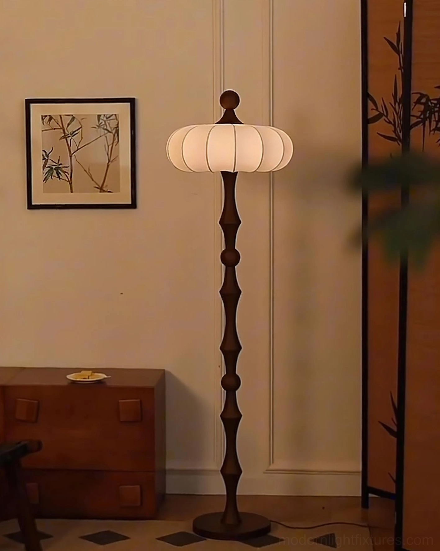 Milo compact vintage floor lamp in small living space with side cabinet and wall prints, dark wooden pole with fabric lantern shade