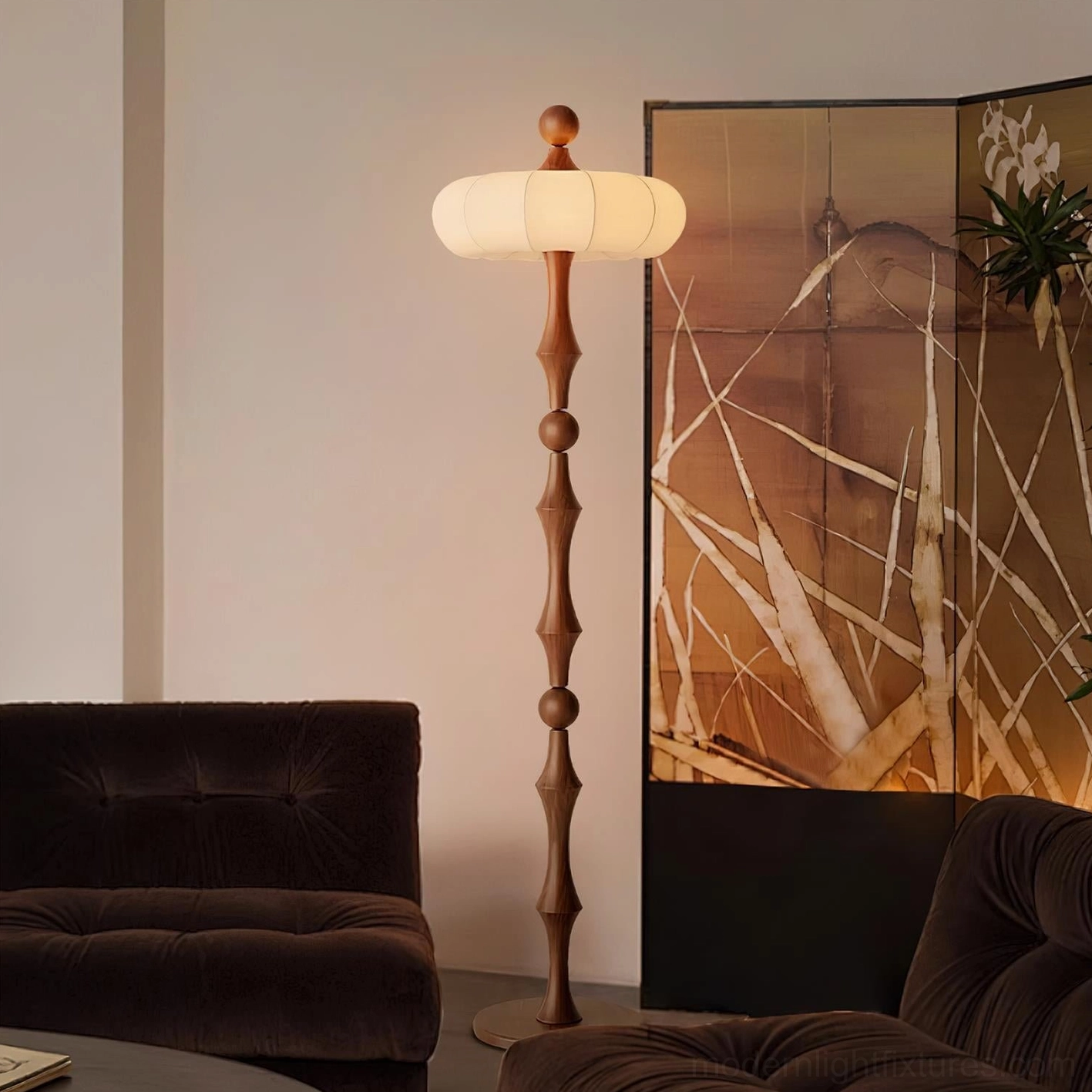 Milo modern floor lamp in living room with dark velvet sofa and folding screen, warm diffused lighting from fabric shade