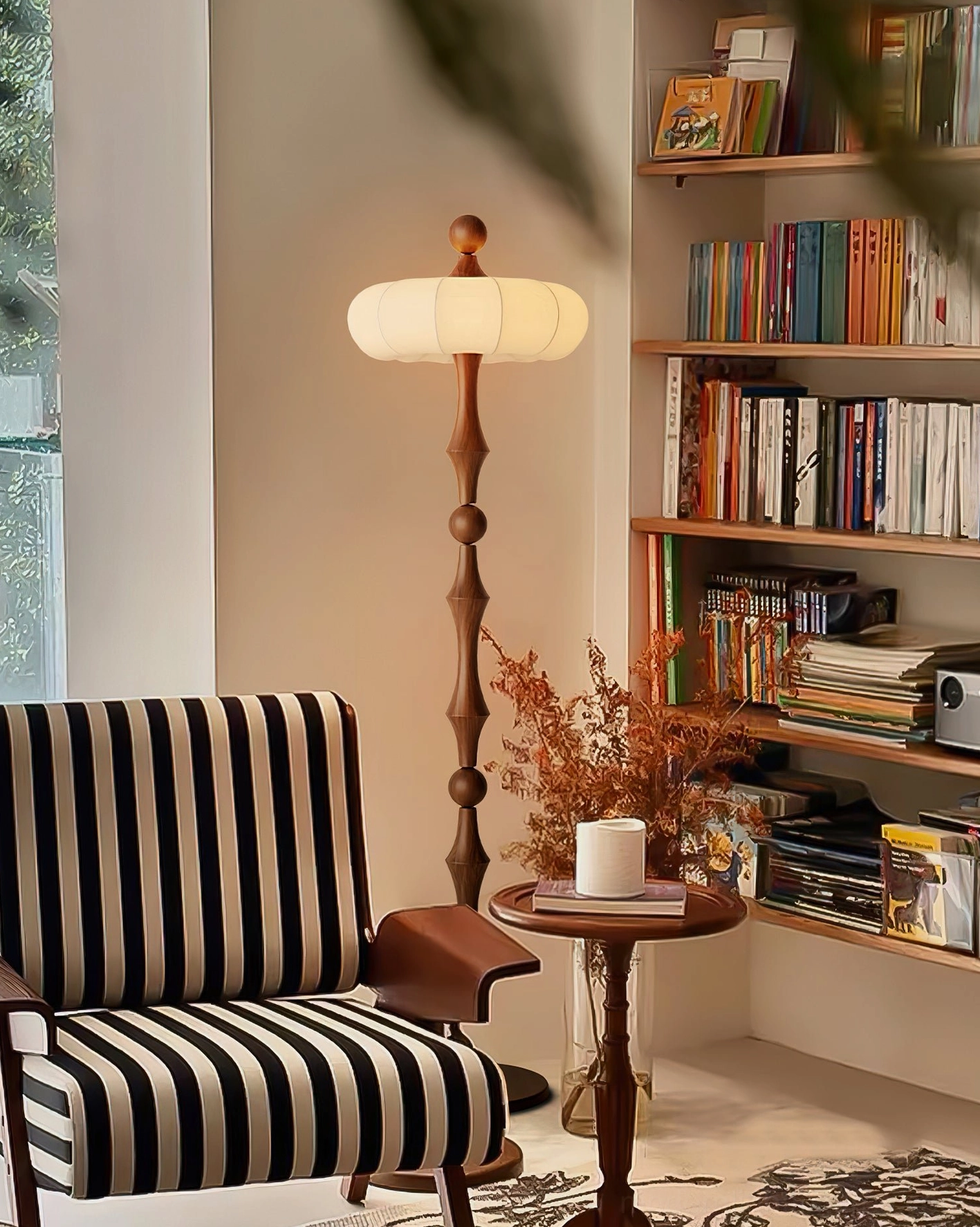 Retro Milo floor lamp in home reading corner with bookshelf and striped armchair, warm ambient lighting from fabric shade