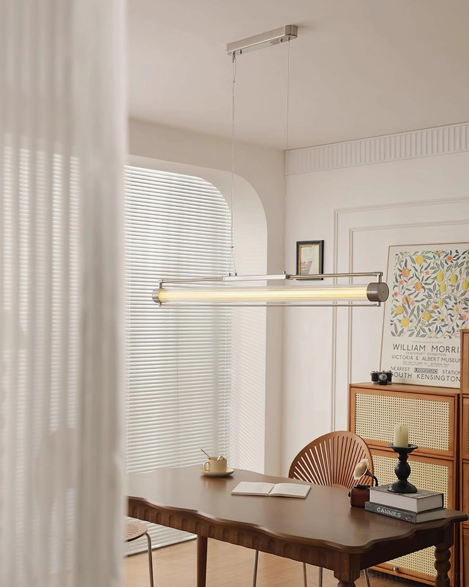 Minimalist linear pendant light in contemporary dining room with sheer curtains - unlit clear glass tube fixture