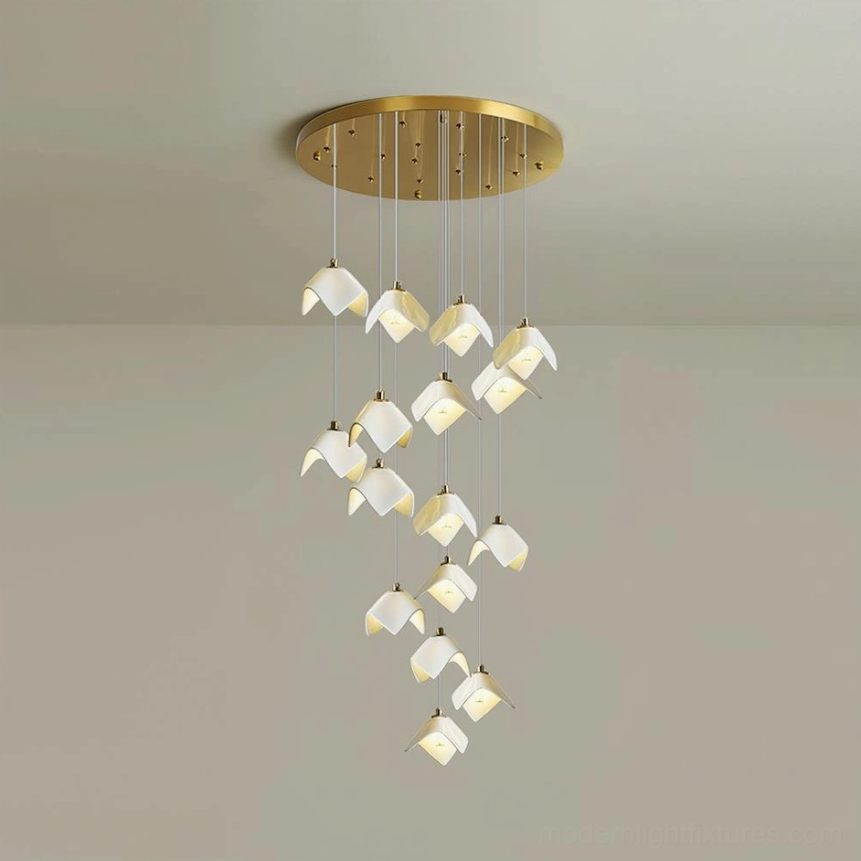 Cascading bloom pendant fixture in minimalist interior creating sculptural focal point above double-height space