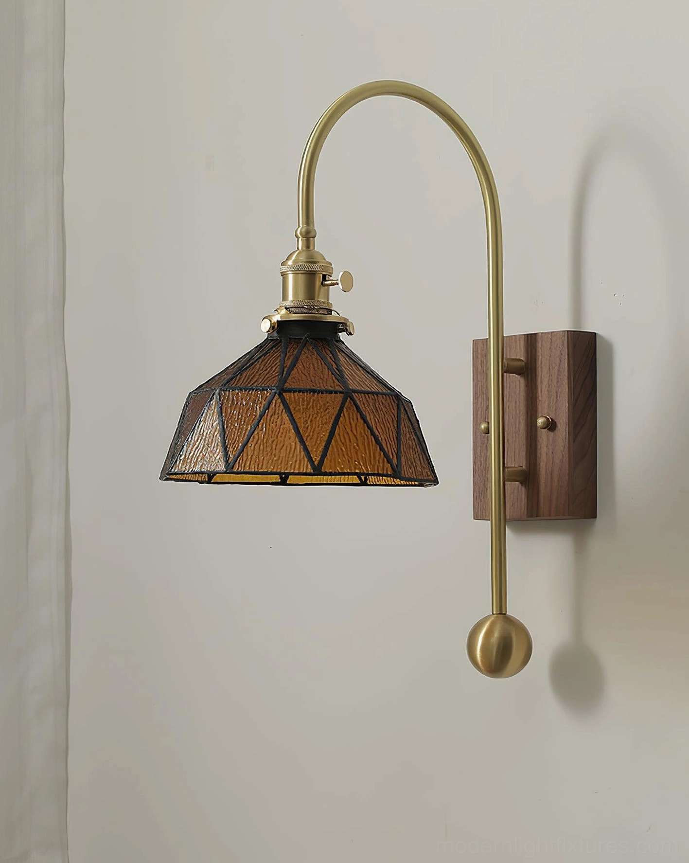 Minimalist brass wall sconce with clean lines and warm stained glass ambient lighting