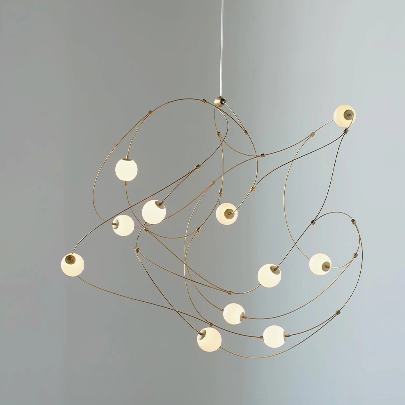 Modern wire frame pendant chandelier with minimalist brass curved elements and spherical acrylic milky shades, overhead perspective