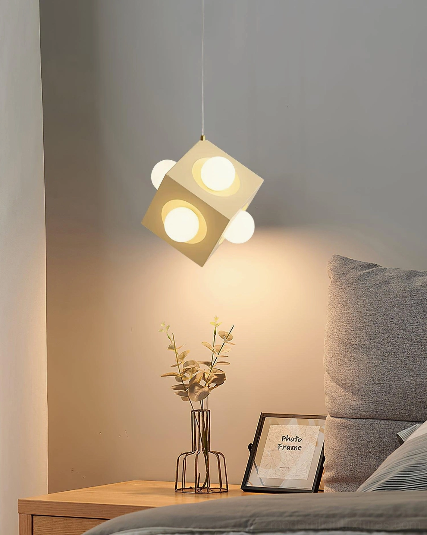 Modern geometric pendant light casting ambient warm illumination in contemporary interior space