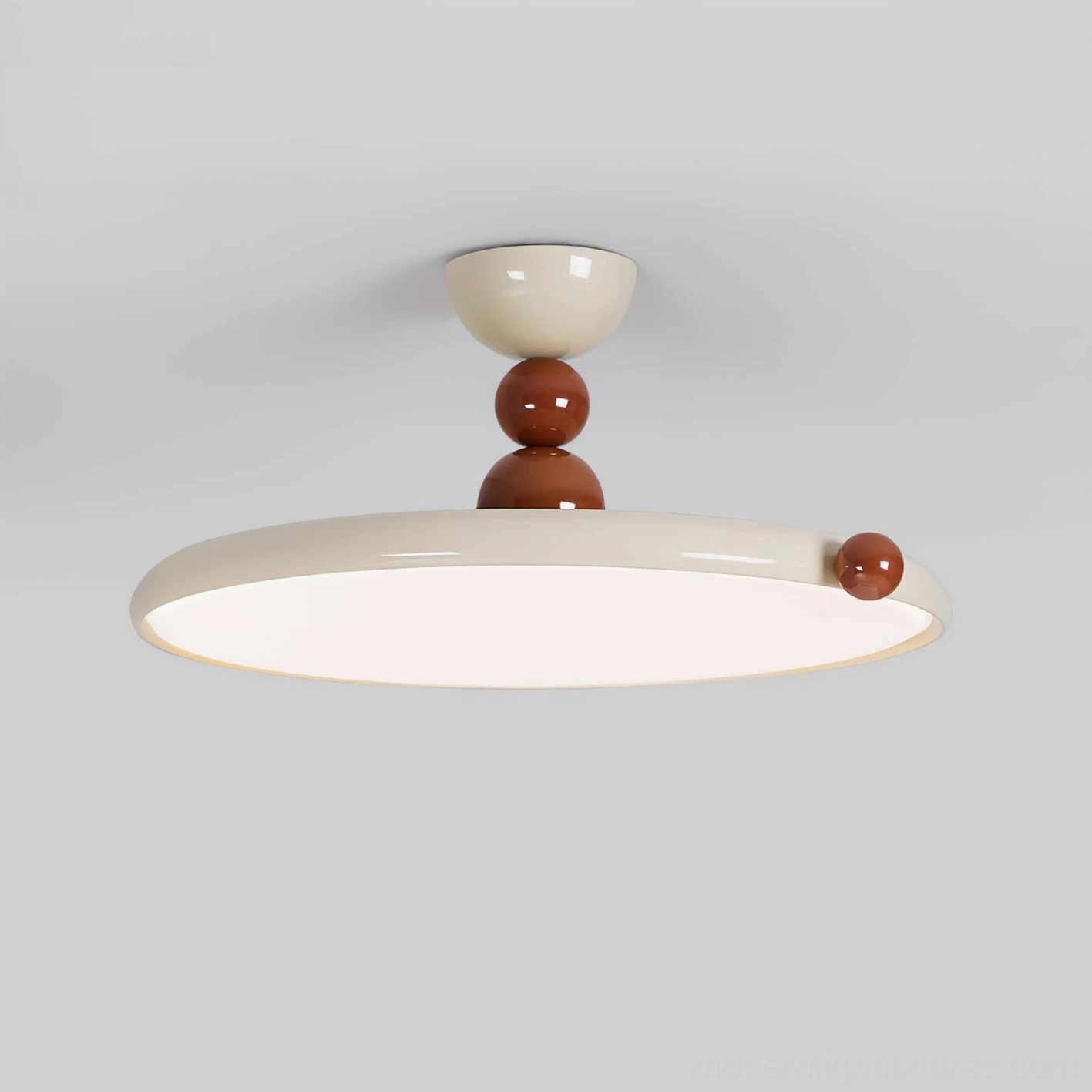 Front low-angle view of disc flush ceiling lamp showing smooth matte cream finish and brown decorative knob detail
