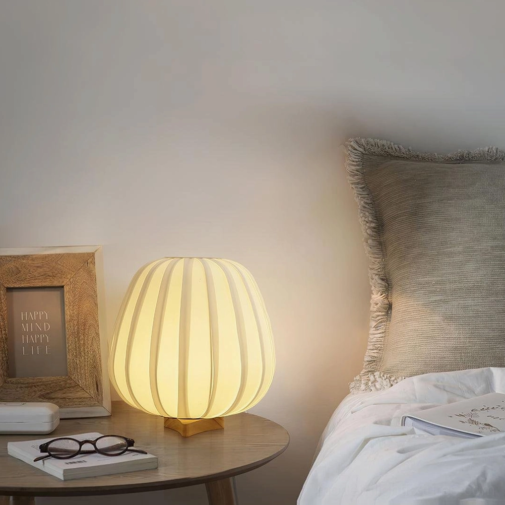 Minimalist fabric table lamp illuminated in elegant home interior setting